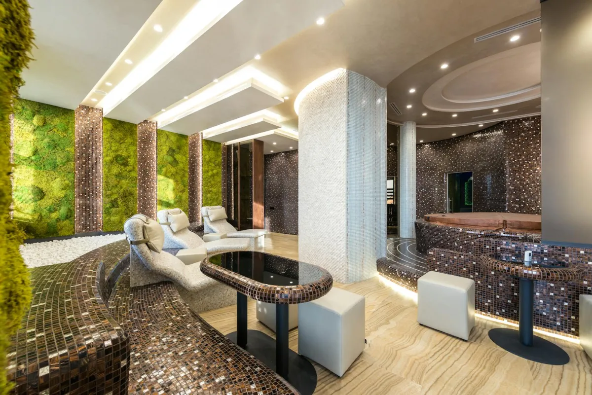 A modern luxury spa interior with loungers and a hot tub