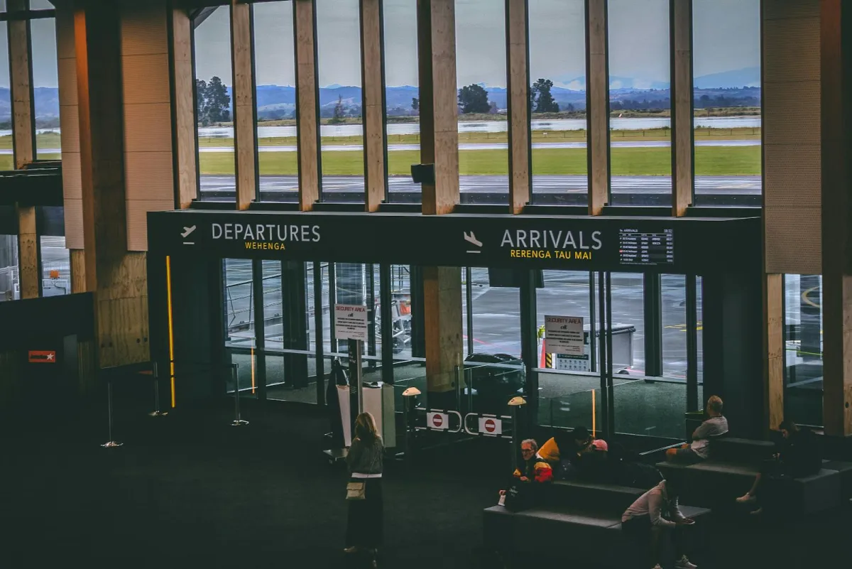An airport terminal with departures and arrivals signage