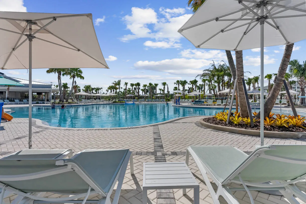 Resort pool with shaded loungers and umbrellas at Windsor Cay Resort