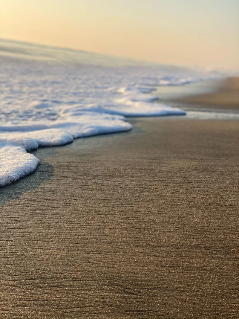 A sandy Florida beach with gentle surf